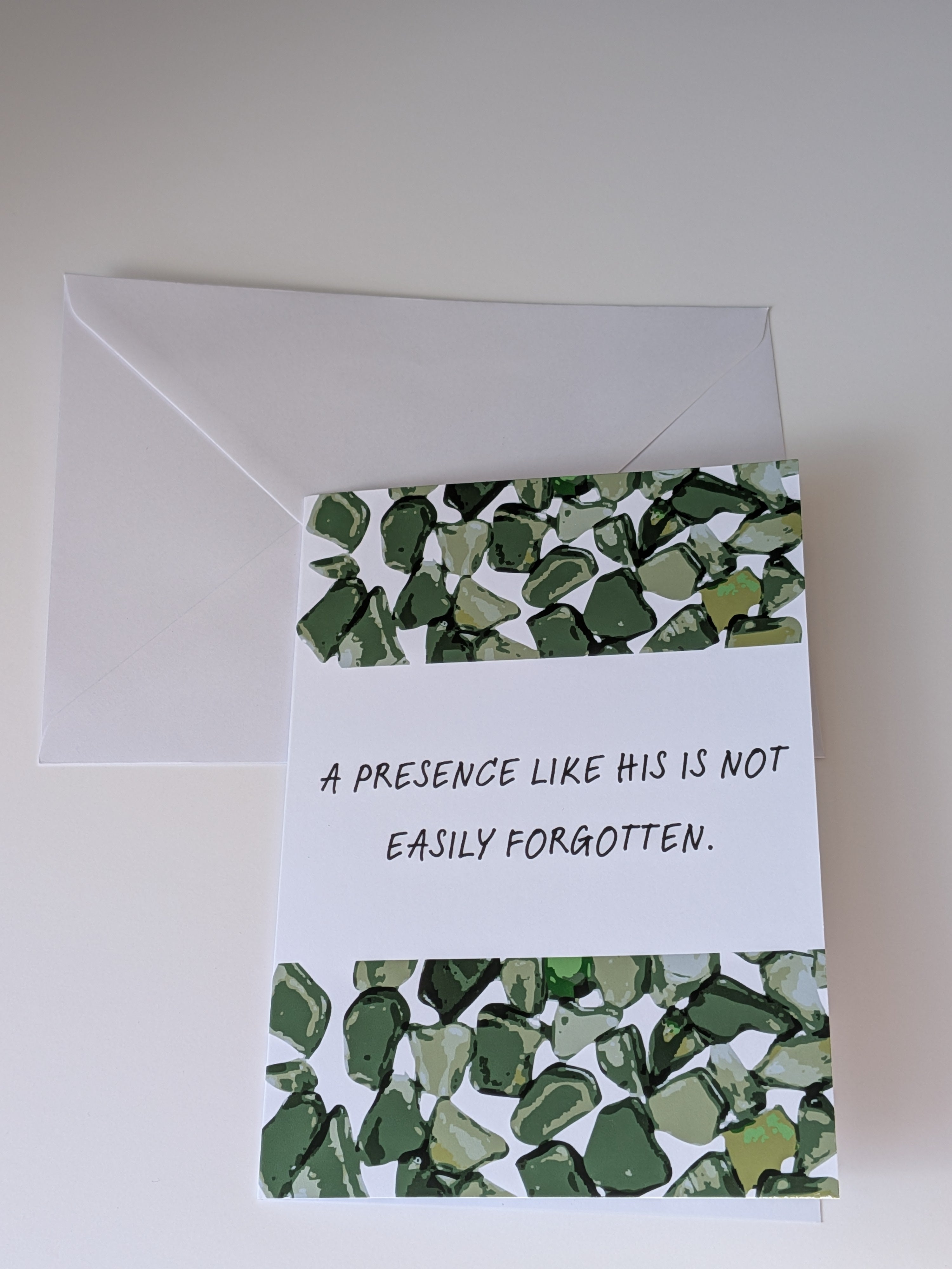Greeting card with green mosaic design and text, featuring an envelope on a white background.